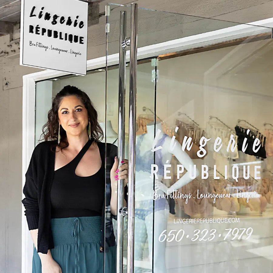 Woman opening a door to Lingerie Republique store